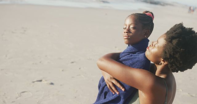 Mother Embracing Daughter Wrapped in Towel on Sunny Beach - Download Free Stock Images Pikwizard.com