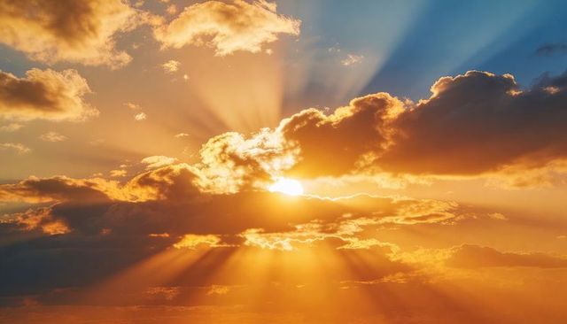 Dramatic Crepuscular Rays and Golden Sunbeams Breaking Through Clouds at Sunrise