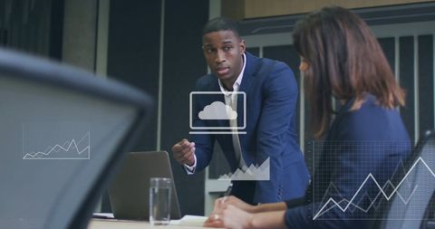Busy Office with Businesspeople Analyzing Financial Data on Screen