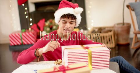Joyful christmas holiday gift wrapping with santa hat