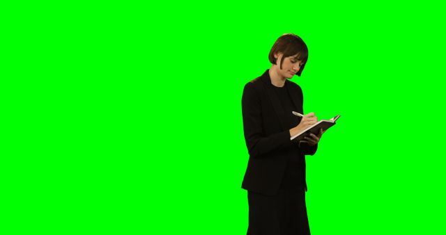 Professional Woman Writing in Notebook on Green Screen Background - Download Free Stock Images Pikwizard.com