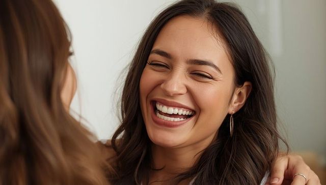 Women Sharing Laughter and Close Friendship in Living Room Embrace