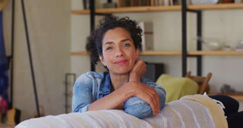Relaxed Woman Smiling on Sofa at Home