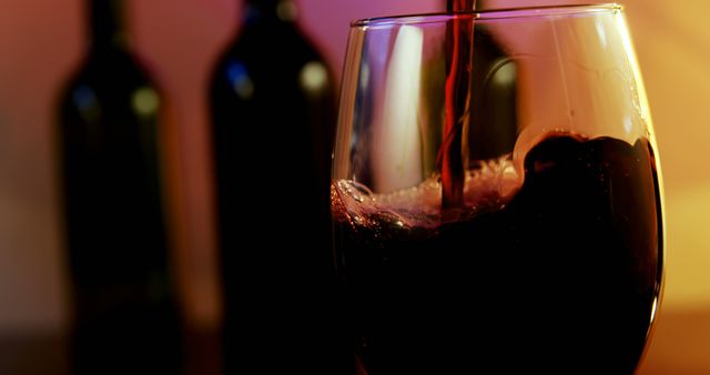 Close-up of Red Wine Pouring into Glass at Night - Download Free Stock Images Pikwizard.com