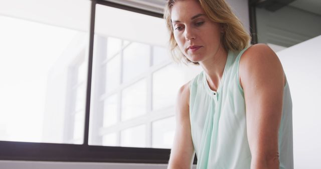 Contemplative Woman in Modern Office with Large Windows - Download Free Stock Images Pikwizard.com