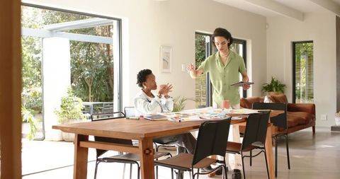 Planning collaborative design at modern dining table with diverse coworkers and color swatches