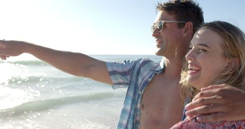 Joyful Couple Enjoying a Relaxed Beach Day in Sunshine