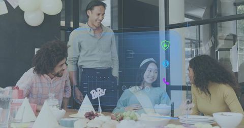 Colleagues celebrating pregnant coworker at office baby shower, laughing around table