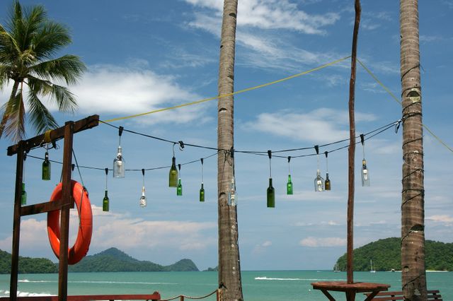 Tropical Beach Outdoor Bar Decor with Bottle Hanging on Rope and Lifebuoy - Download Free Stock Images Pikwizard.com