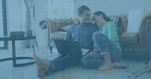 Happy Couple Reviewing Financial Data in Living Room