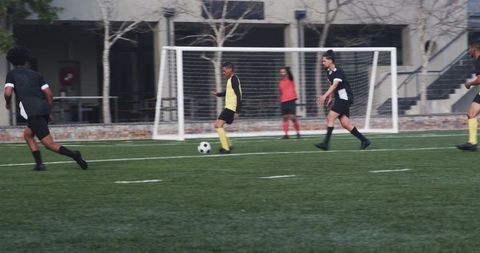 Youth soccer players practice team skills on field