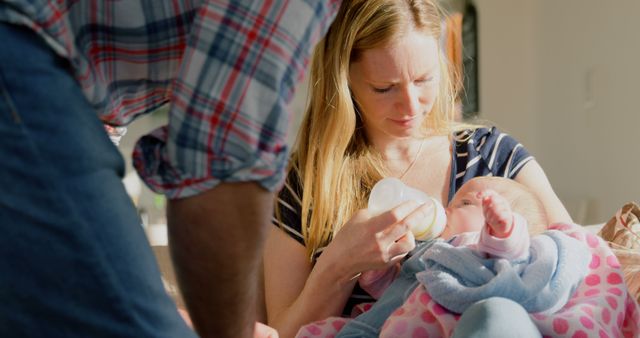 Mother Feeding Baby with Help from Father - Download Free Stock Images Pikwizard.com