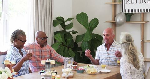 Senior Friends Enjoy Casual Gathering at Home with Snacks