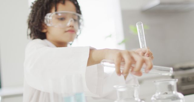 Child in a lab coat and safety goggles conducting science experiment with test tubes. Ideal for educational materials, promoting STEM education, and illustrating children's involvement in science. Can be used in school science curriculums, educational blog posts, or advertisements for children's science kits.