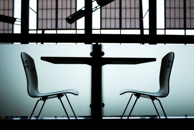 Empty modern chairs and table in an office setting - Download Free Stock Photos Pikwizard.com