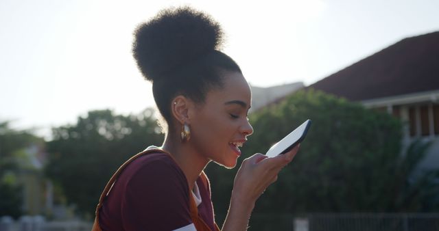 Young Woman Using Voice Command Feature on Smartphone Outdoors - Download Free Stock Images Pikwizard.com