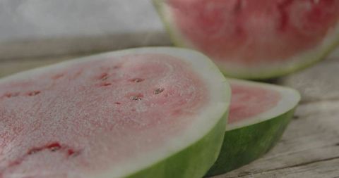 Half-Sliced Watermelon on Rustic Wooden Board