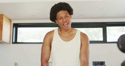 Young African American Man Filming Cooking Vlog at Home