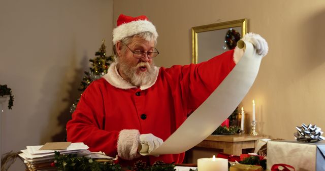 Santa Claus reading a long gift list in a festive setting. Christmas tree and decorations in the background enhance the holiday spirit. Perfect for illustrating Christmas traditions, holiday greetings, seasonal promotions, or festive blog posts.