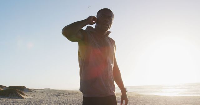 Athletic Man Stretching on Beach During Sunset - Download Free Stock Images Pikwizard.com