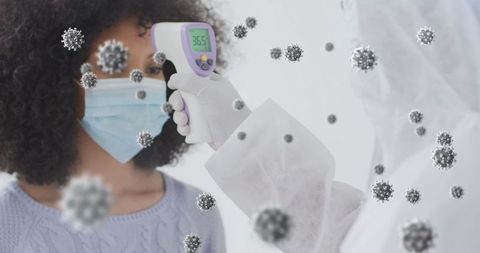 Medical professional checks temperature of masked patient with virus visuals