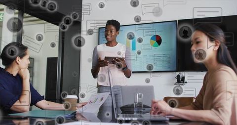 Team leader presenting with tablet in modern boardroom showing charts and teamwork