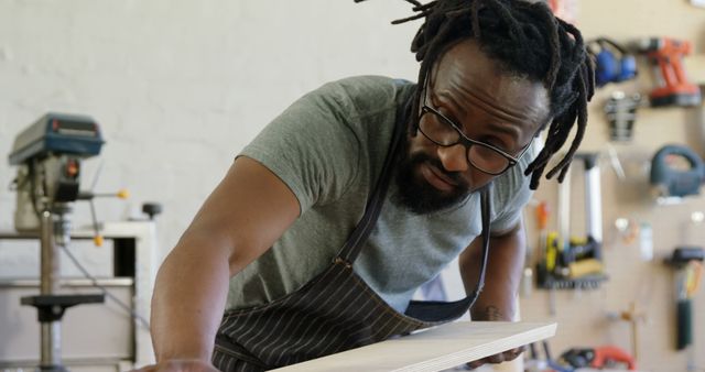 Focused Carpenter Sanding Wooden Plank in Workshop - Download Free Stock Images Pikwizard.com