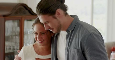 Happy Couple Smiling and Embracing at Home