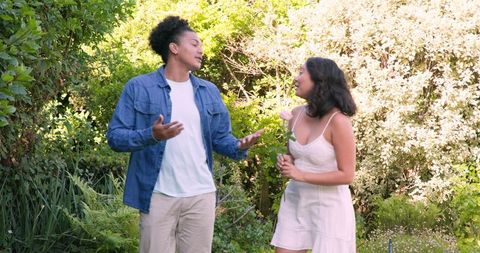 Bride smiling with partner in lush garden