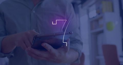 Business professional using tablet with glowing 7 in office