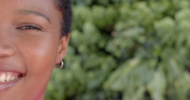 Close-Up of Woman Smiling Outdoors with Natural Greenery Background - Download Free Stock Images Pikwizard.com