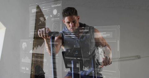 Man pedaling stationary bike holding digital globe with futuristic fitness hud overlay