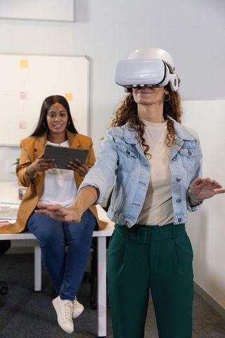Female team testing vr headset in office collaborating on immersive design workshop session