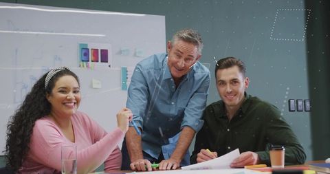 Creative team brainstorming smartphone designs in modern office