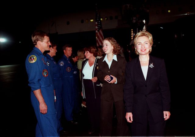 First Lady Hillary Rodham Clinton (right) and her daughter, Chelsea, are greeted by NASA Astronaut Scott E. Parazynski (left) upon their arrival at the Skid Strip at Cape Canaveral Air Station to view the launch of Space Shuttle mission STS-93. Liftoff is scheduled for 12:36 a.m. EDT July 20. Much attention has been generated over the launch due to Commander Eileen M. Collins, the first woman to serve as commander of a Shuttle mission. The primary payload of the five-day mission is the Chandra X-ray Observatory, which will allow scientists from around the world to study some of the most distant, powerful and dynamic objects in the universe. The new telescope is 20 to 50 times more sensitive than any previous X-ray telescope and is expected to unlock the secrets of supernovae, quasars and black holes