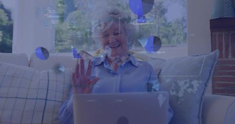 Senior woman waving during virtual call with digital analytics and dashboard overlays