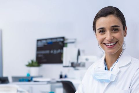 Smiling Female Scientist in Laboratory with Equipment