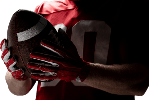 Transparent rugby football in focus with player in red jersey