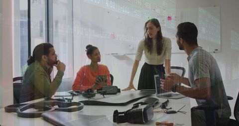 Tech team collaborating on drone assembly with gadgets and vr technology