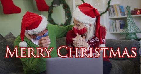 Elderly couple enjoying virtual christmas celebration with santa hats
