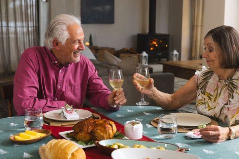 Senior Couple Toasting at Cozy Home Dining Table