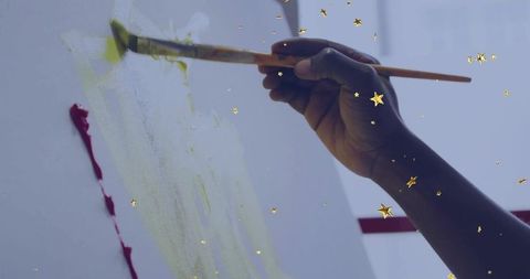 Hand Painting Canvas with Yellow-Green Hue in Creative Studio Ambience