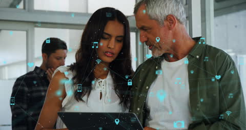 Senior Man and Colleague Discuss Digital Project in Modern Office