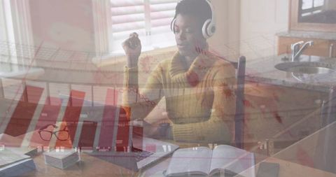 African American Woman with Headphones Using Laptop for Data Processing