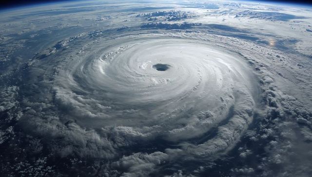 Rotating tropical cyclone from orbit revealing clear eye, eyewall and spiral rainbands