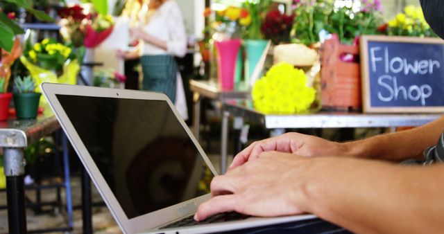 Person Typing on Laptop in Flower Shop - Download Free Stock Images Pikwizard.com