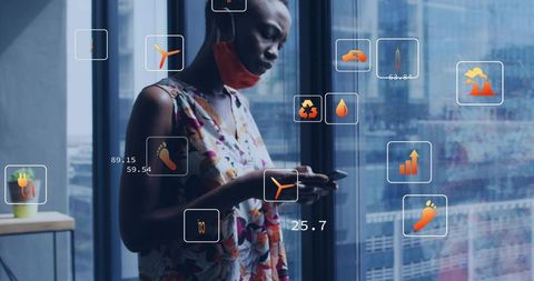 Woman using smartphone, interacting with augmented reality sustainability icons in high-rise office