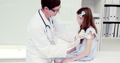Doctor Applying Bandage to Child's Arm in Healthcare Setting - Download Free Stock Images Pikwizard.com