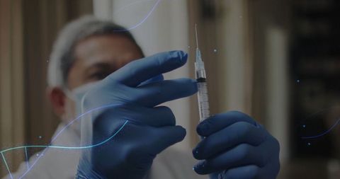 Medical professional preparing syringe for injection