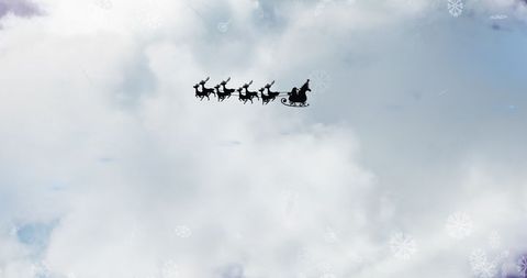 Santa Sleigh Silhouette Against Cloudy Winter Sky with Falling Snow - Download Free Stock Images Pikwizard.com